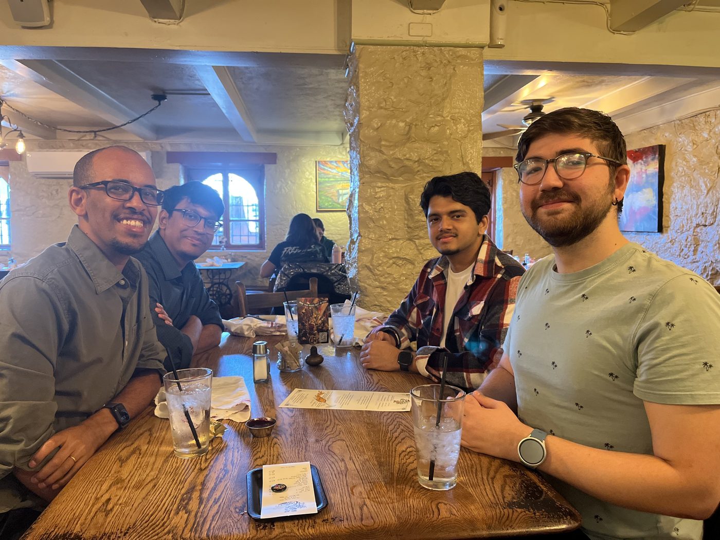 Lab members smiling around a restaurant table