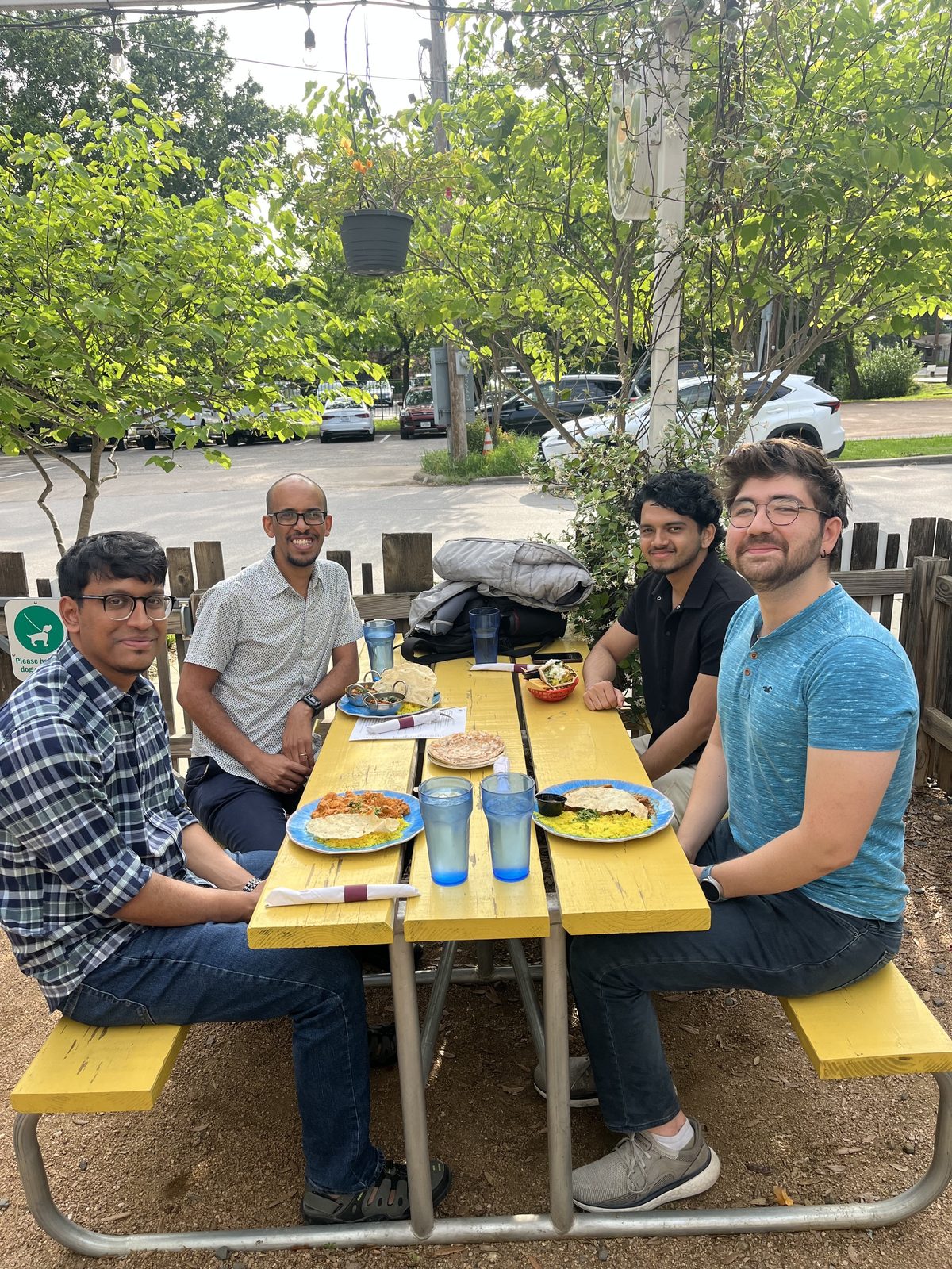 Lab members having lunch together at an outdoor picnic table