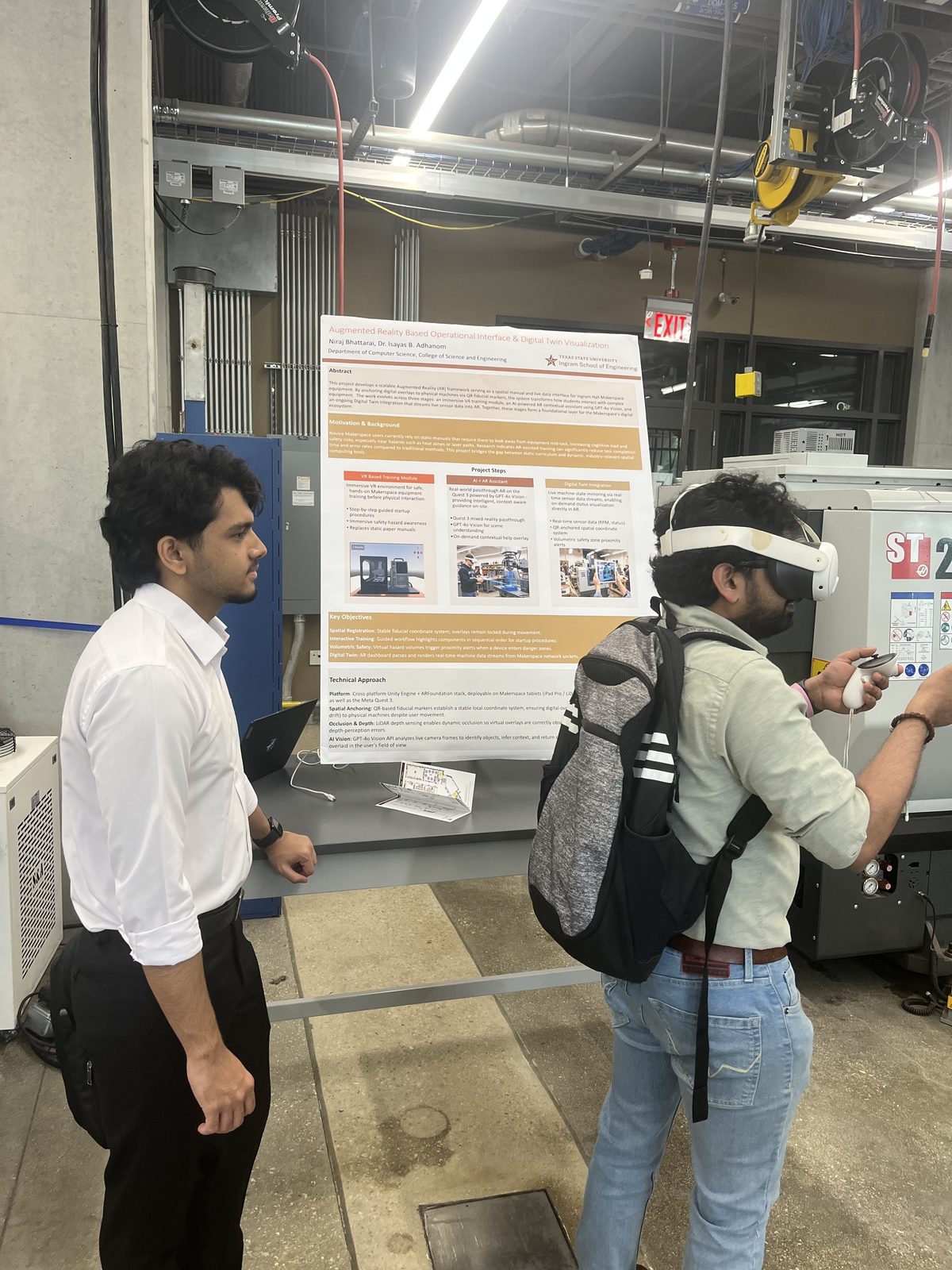 A student wearing a headset tries the AR digital-twin demo next to the project poster
